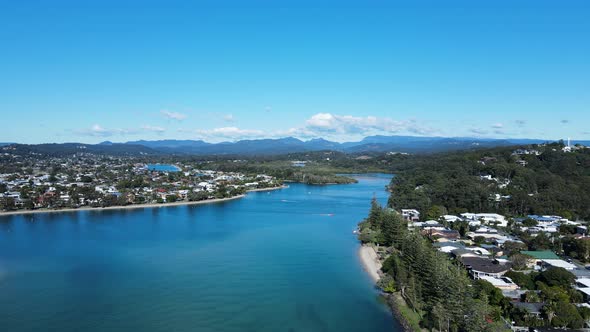 Scenic panoramic view of a large inland estuary with mountain peaks and clouds in the foreground. Hi