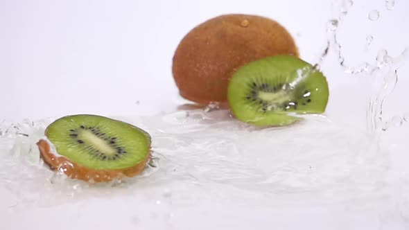 A Several Slices of Kiwi are Falling on the Table