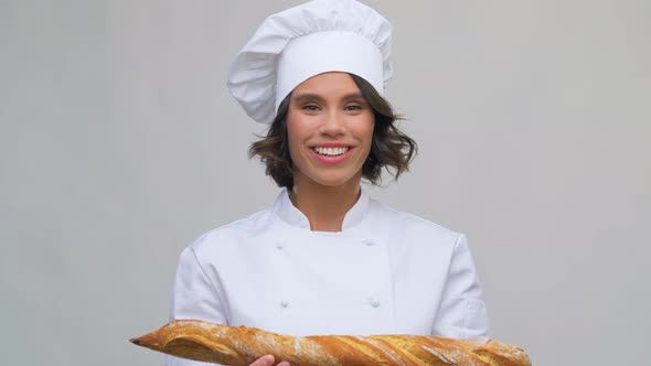 Happy Female Chef with French Bread or Baguette