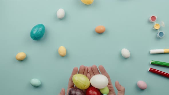 Hand with Painted Easter Eggs Comes Out