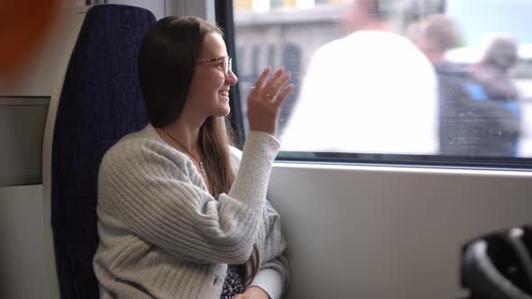 Close Shot of Young Attractive Ukraine Female in Glasses Sitting on Moving City Metro Train