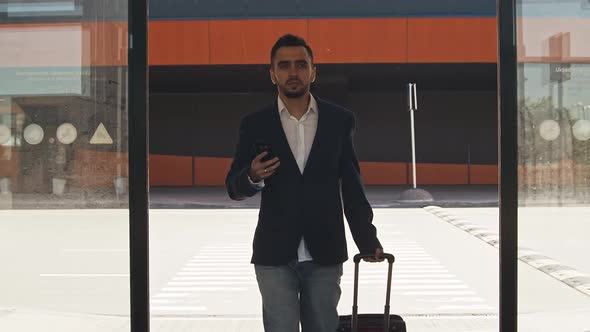 Elegant businessman in airport. Young mail entrepreneur in formalwear.