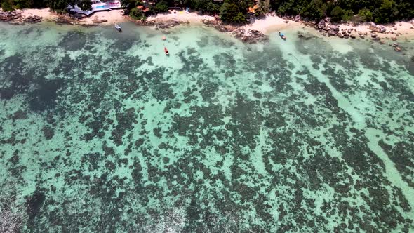 Overhead Aerial Over Tranquil Coral Waters Towards Beach At Koh Lipe. Dolly Dolly Forward