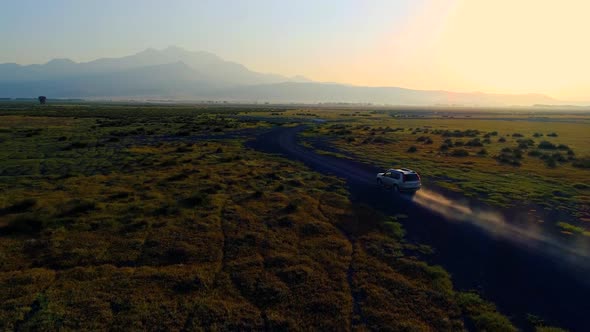 Car Driving On Dirt Road Sun 