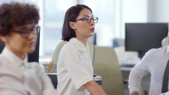 Caucasian Businesspeople Exercising and Talking in Office