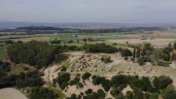 Majestic drone shot of the monumental archaeological museum Ullastret in Catalonia.