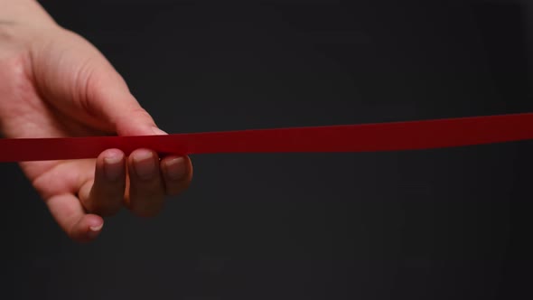 Hand with Scissors Cutting Red Ribbon Opening Ceremony Concept