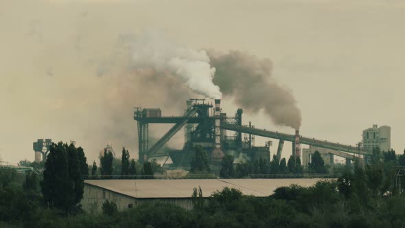 Thick smoke flies from industrial pipes into the sky, time lapse footage.