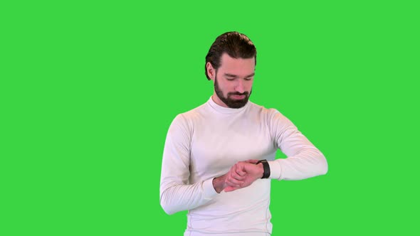 Handsome Sportsman Checking Smart Watch While Walking on a Green Screen Chroma Key