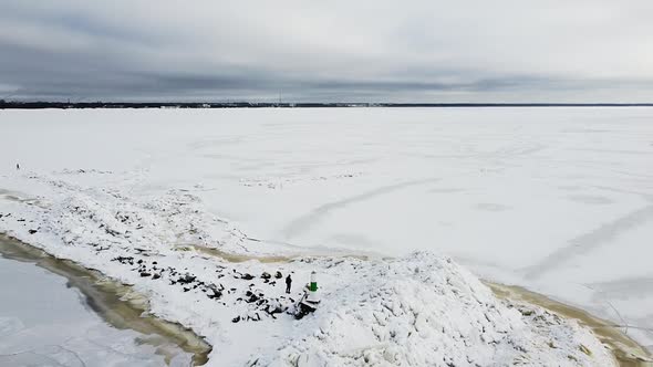 Aerial drone view of a frozen mole in the middle of a frozen sea. Recorded above Mole of Pärnu (Pärn