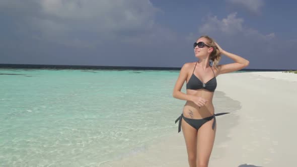 Smiling Woman Running Along Beach