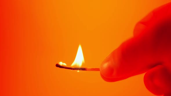 Burning Match in Hand Illuminated By Flashing Light Fire Flasher