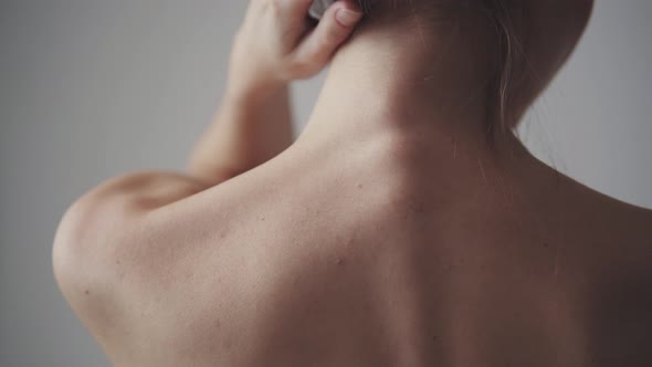 Female Shoulders Close Up. Girl Touches Her Neck and Shoulders