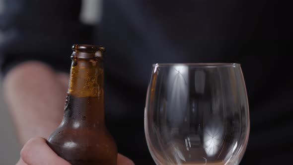 Bottle of Beer with Drops Pouring