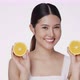 Cute female model clean fresh skin is holding an orange. Expressive facial expressions. Cosmetology. - VideoHive Item for Sale