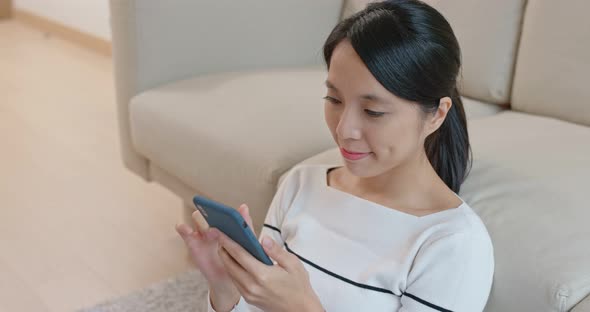 Woman look at mobile phone at home