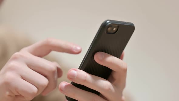 Hand Close Up of Young Man Using Smartphone