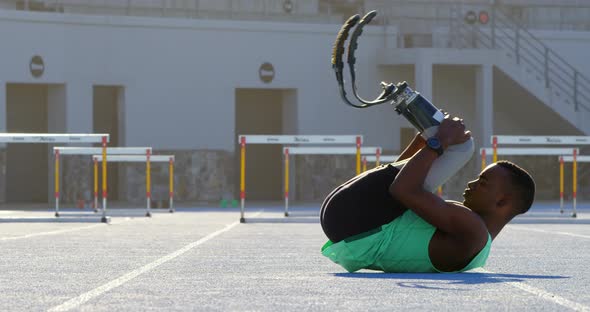 Disabled athletic exercising on a running track 4k