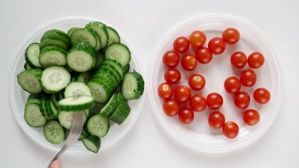 Man on Diet Eats Chili Tomato and Cucumber From Plate