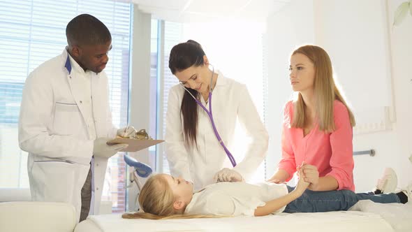 Colleagues Doctors Examining Health of Girl Patient