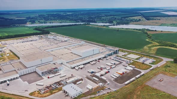 Aerial footage of a large industrial complex with Car parking place and great perspective of city