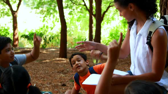 Woman interacting with kids in park