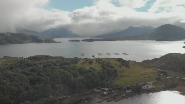 Aerial drone shot of beautiful scottish landscape in north highlands with lake bay and green mountai