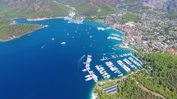 Small City Houses, Beautiful Marina and Touristic Boats in a Cove Surrounded by Forest by Sea