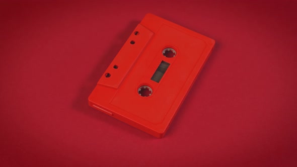 Old Red Cassette Tape on a Minimalist Background