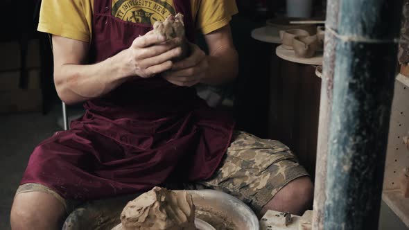 Serious Woman Working at Pottery Wheel in Studio Prepare Clay to Make Plate to Restaurant