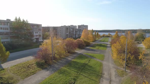 Drone view of park with trees in provincial city with soviet panel houses 34