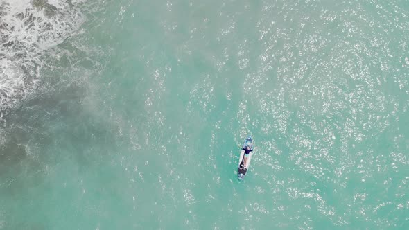 Woman Lies on Sup Board