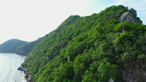 4K aerial view of mountain coast near beautiful beach and sea. Flight over sea.