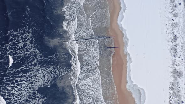 Snowy beach at Baltic sea. Winter tourism, Poland. Aerial view