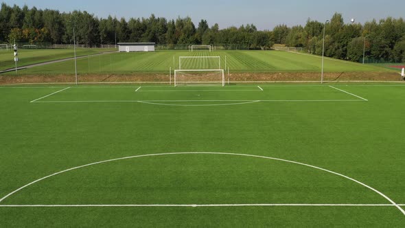 Top View of a Football Field with Green Grass Outdoors in Summer