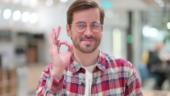 Attractive Male Designer Showing Ok Sign with Hand