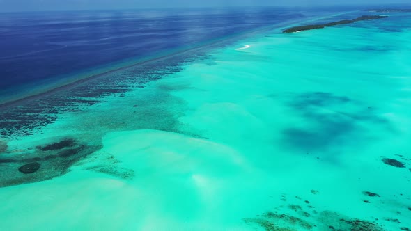 Wide aerial tourism shot of a white sand paradise beach and aqua turquoise water background in best 
