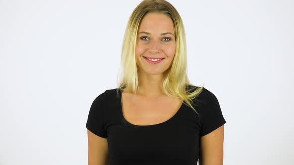 A Young Beautiful Woman Waves at the Camera with a Smile - White Screen Studio