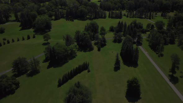 An aerial drone shot revealing the Olympic Stadium in Montreal from Maisonneuve park, during summer