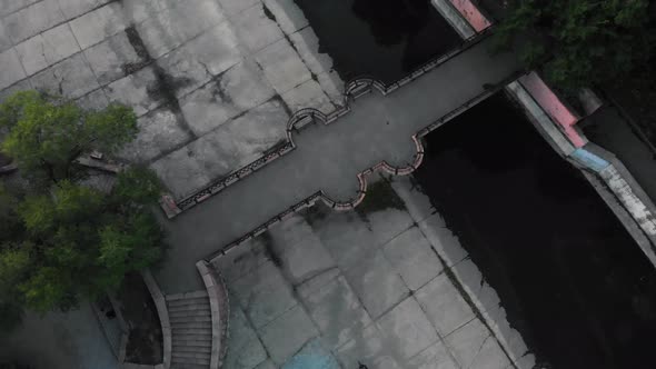 Aerial Top View of Bicyclist Ride Under Bridge Near River in Almaty Kazakhstan