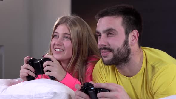 Couple Playing Video Games on the Bed, Slowmotion, Closeup