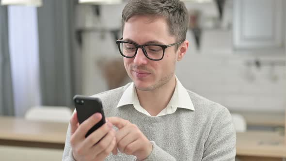 Portrait of Young Man Using Smartphone