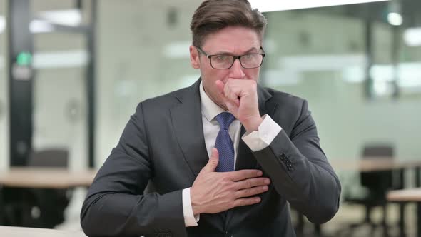 Sick Middle Aged Businessman Coughing