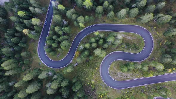 Aerial view on the road and forest at the autumn time. Dolomite Alps, Italy. Forest and road.