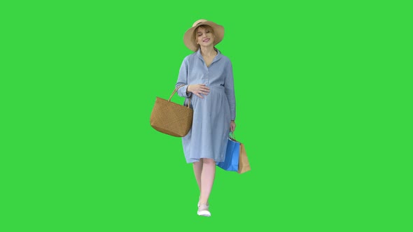 Pregnant Woman in Summer Clothes Walking with Shopping Bags on a Green Screen Chroma Key