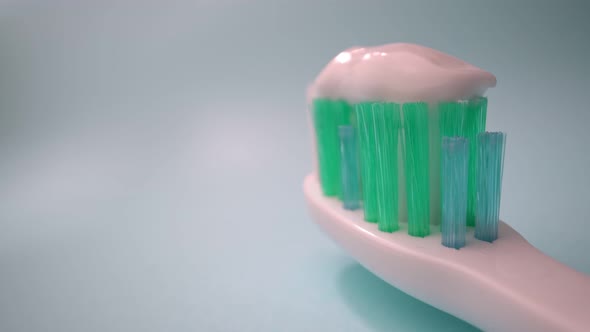 Extreme Macro Video Filming Toothbrush on a Blue Background in Motion Toothpaste on the Brush