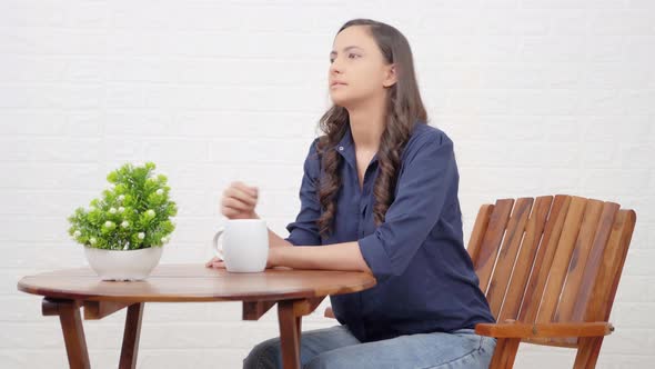 Indian girl waiting for someone at a cafe