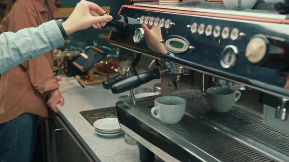 Making a cup of strong coffee in a coffee machine, the back light illuminates the steam and the cup.