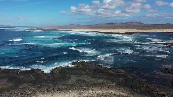 Waves of the Atlantic Ocean crash on coastal rocks