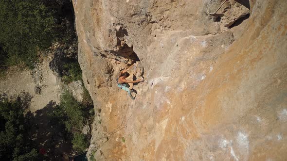 Top View Strong Handsome Man Rock Climber Climbs Up Sunny Limestone Wall By Challenging Route